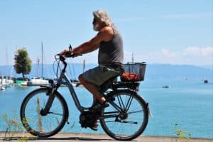 A man cycling with an electric bike with the title best electric bike for seniors